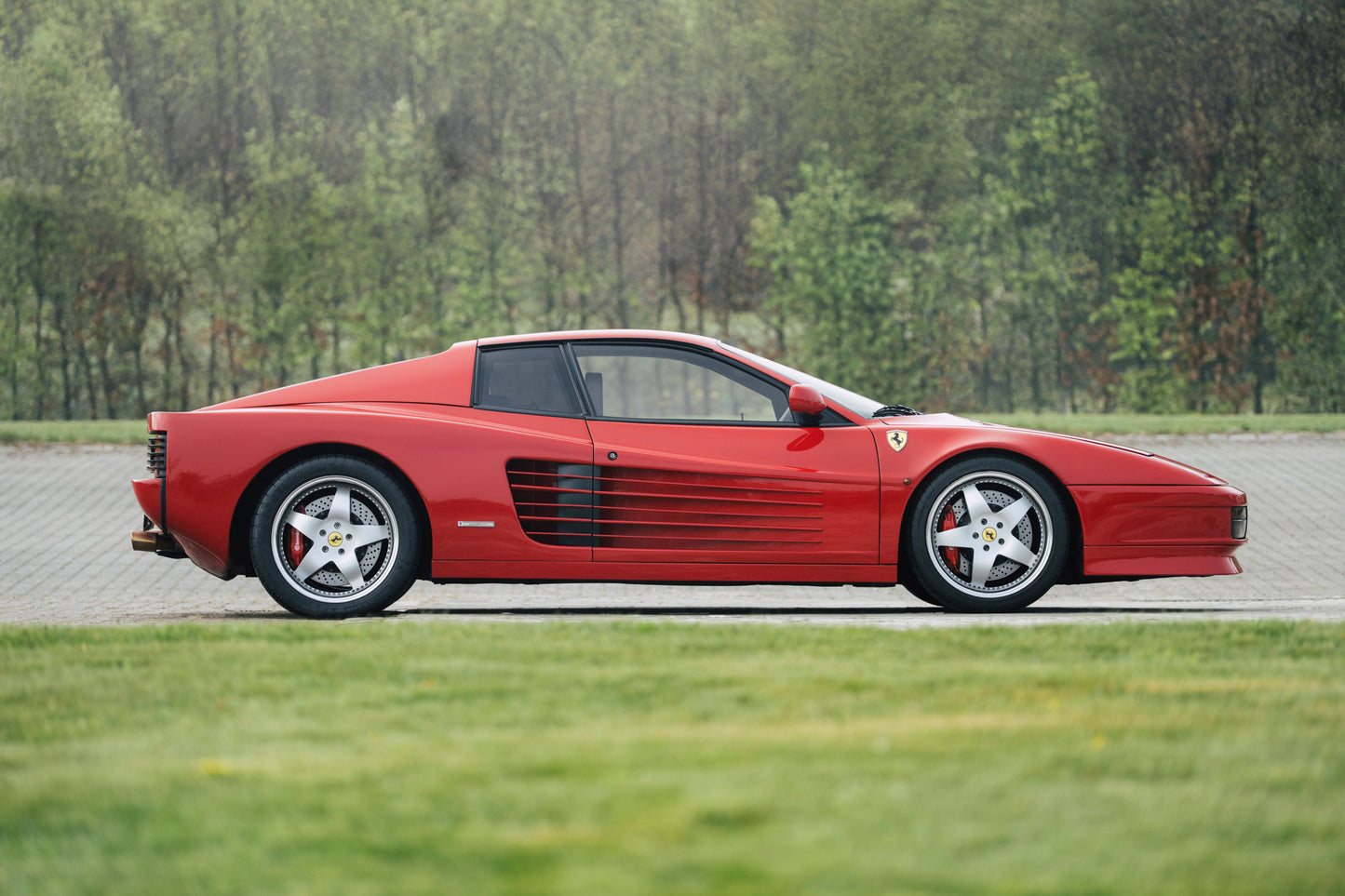 Elegant side profile of a 1991 Ferrari Testarossa for sale.