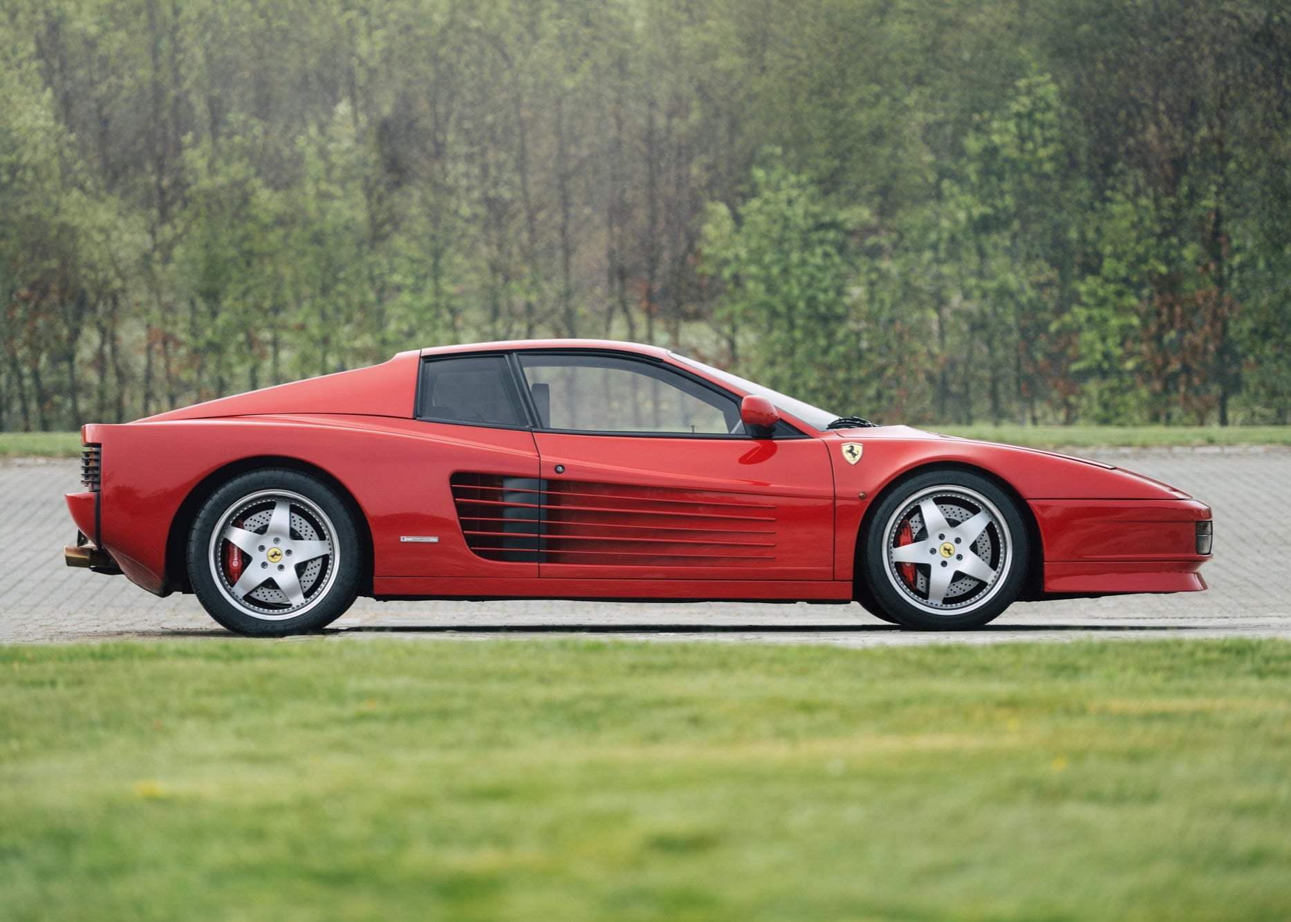 Elegant side profile of a 1991 Ferrari Testarossa for sale.