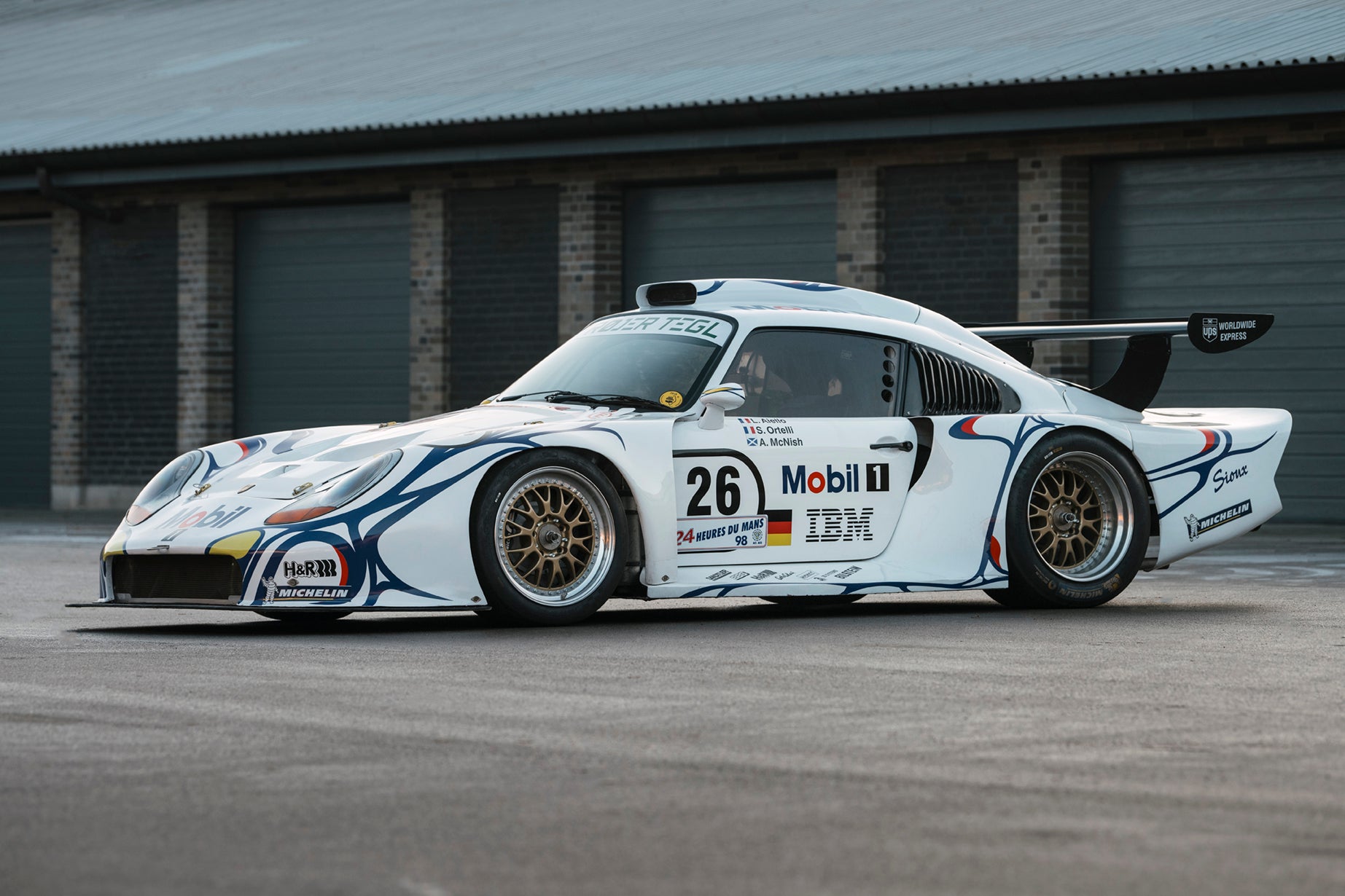1997 Porsche 911 GT1 parked in front of garage.
