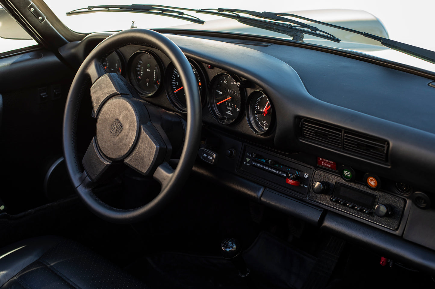 Black dashboard and steering wheel. 1975 Porsche 911S Targa.