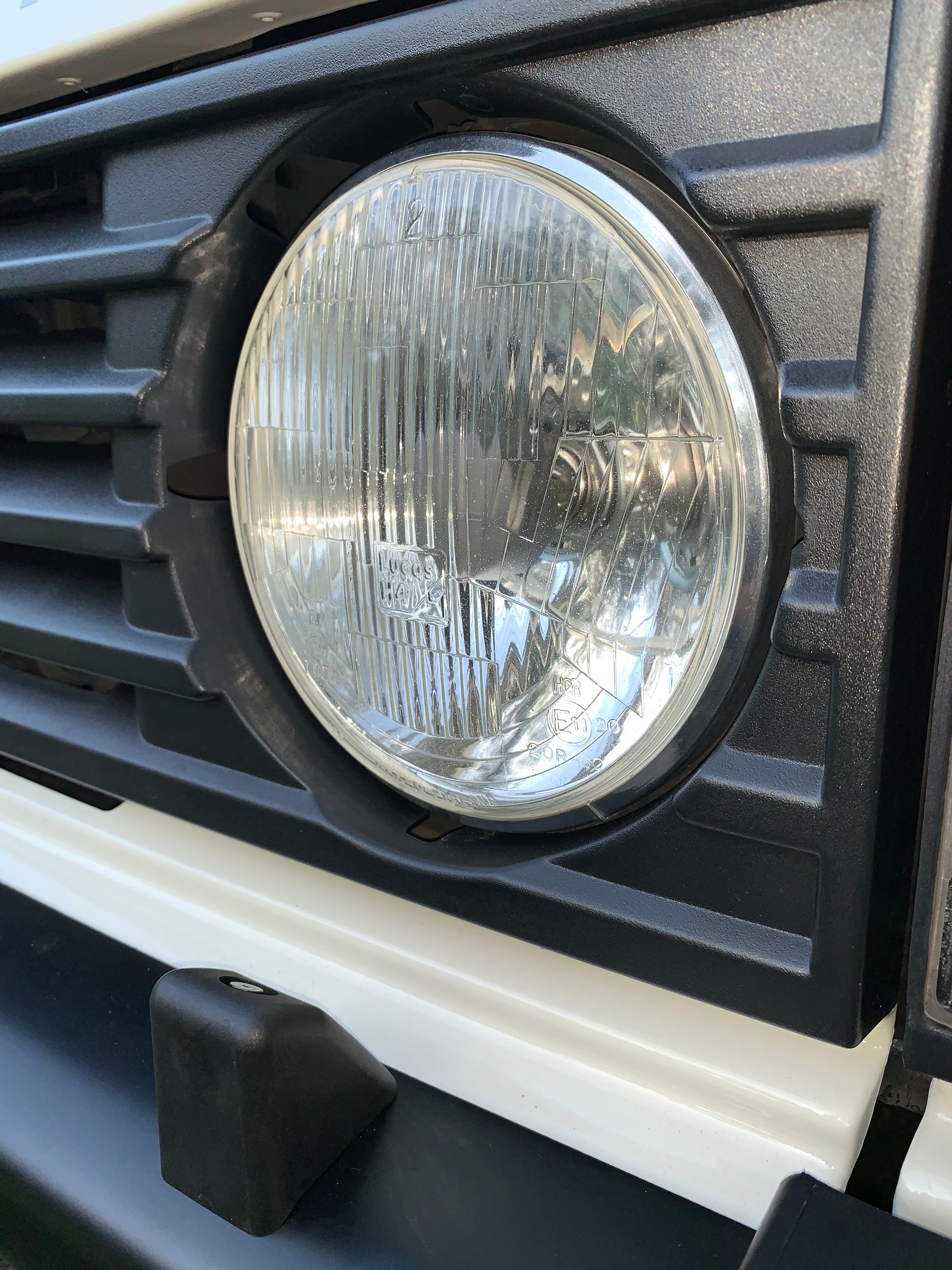 Headlight closeup. 1988 Range Rover Vogue SE classic car.