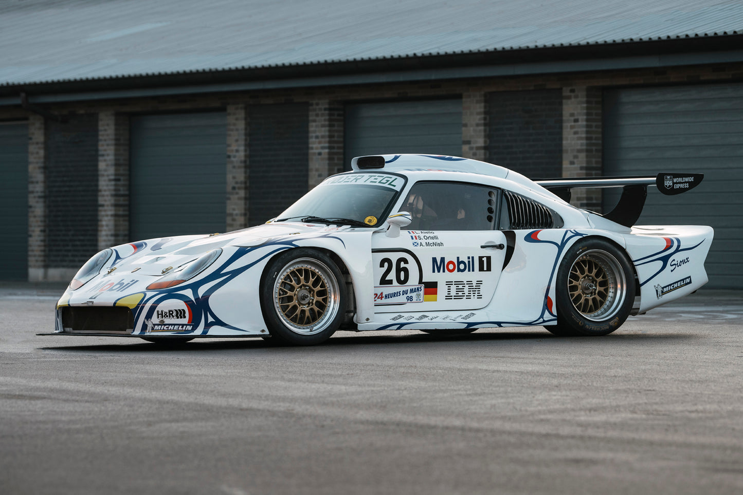 1997 Porsche 911 GT1 parked in front of garage.