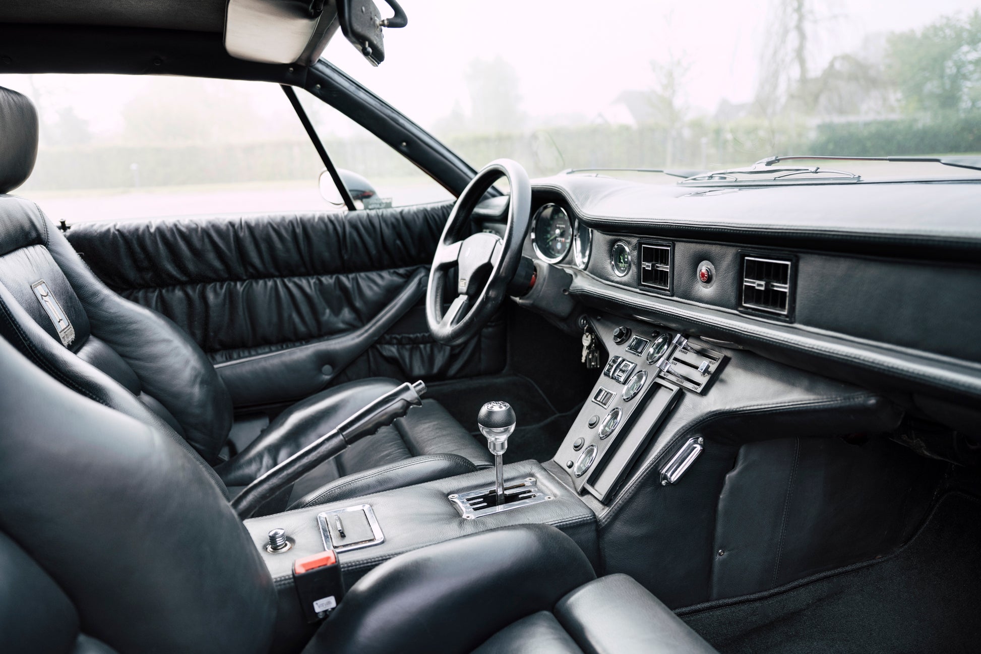 All-black cabin interior. 1973 DeTomaso Pantera To GT5-S Specification.